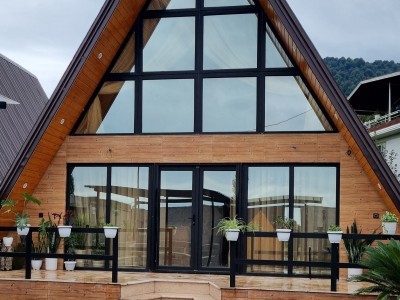 کلبه سوئیسی کیکا، زیر بام سبز با منظره جنگل و بام کلبه سوئیسی کیکا، زیر بام سبز با منظره جنگل و بام